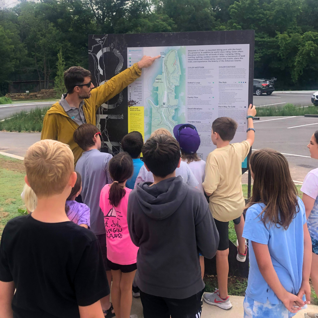 Instructor Scott Dirksen talks to the kids about mountain bike trails at Coler using the Coler trail map
