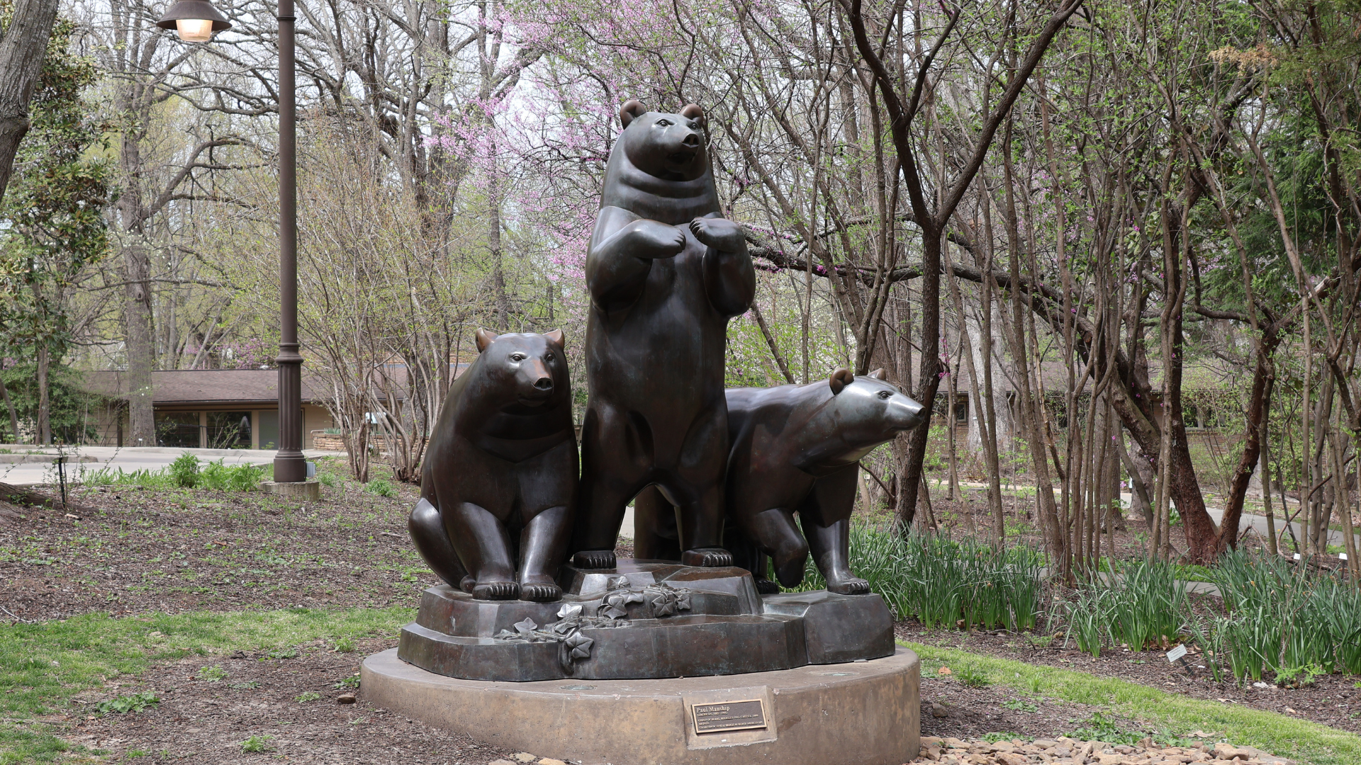Photo of the Three Bears bronze statue at Compton Gardens & Arboretum in the springtime