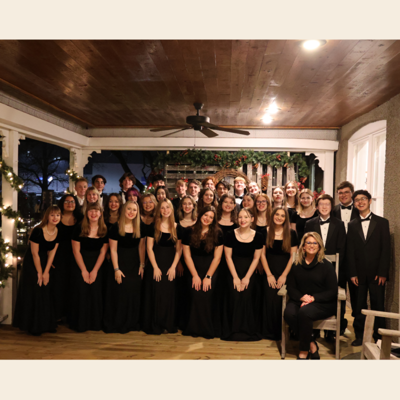 Bentonville West Choir - Group of students on outside porch wearing black and smiling in Bentonville AR