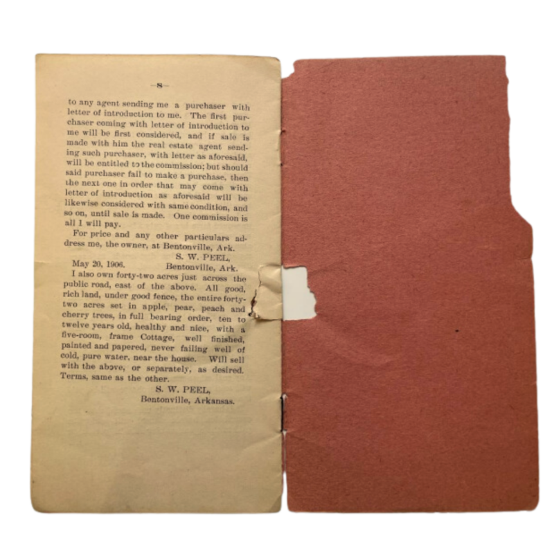 Old paper book that is opened to the last page - with a red orange paper cover. The paper is worn and aged. The content of the book is about Peel Museum and Botanical Garden in Bentonville, Arkansas.