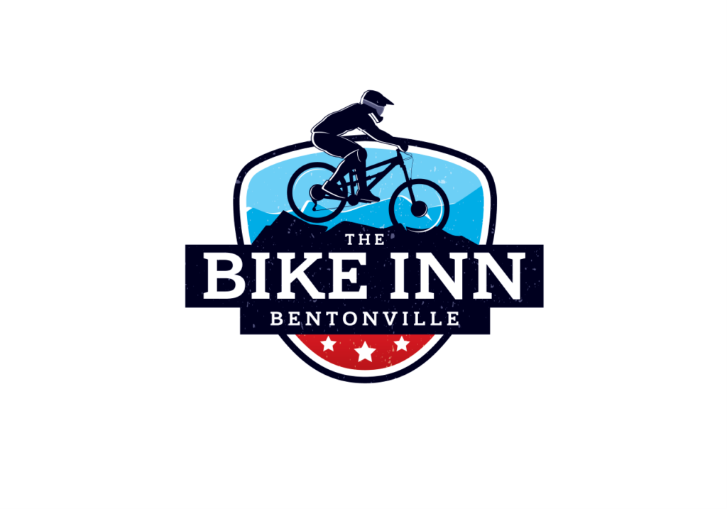 Bike Inn Bentonville logo (mountain biker pictured over top of "The BIKE INN Bentonville" title. Designed like a badge.)