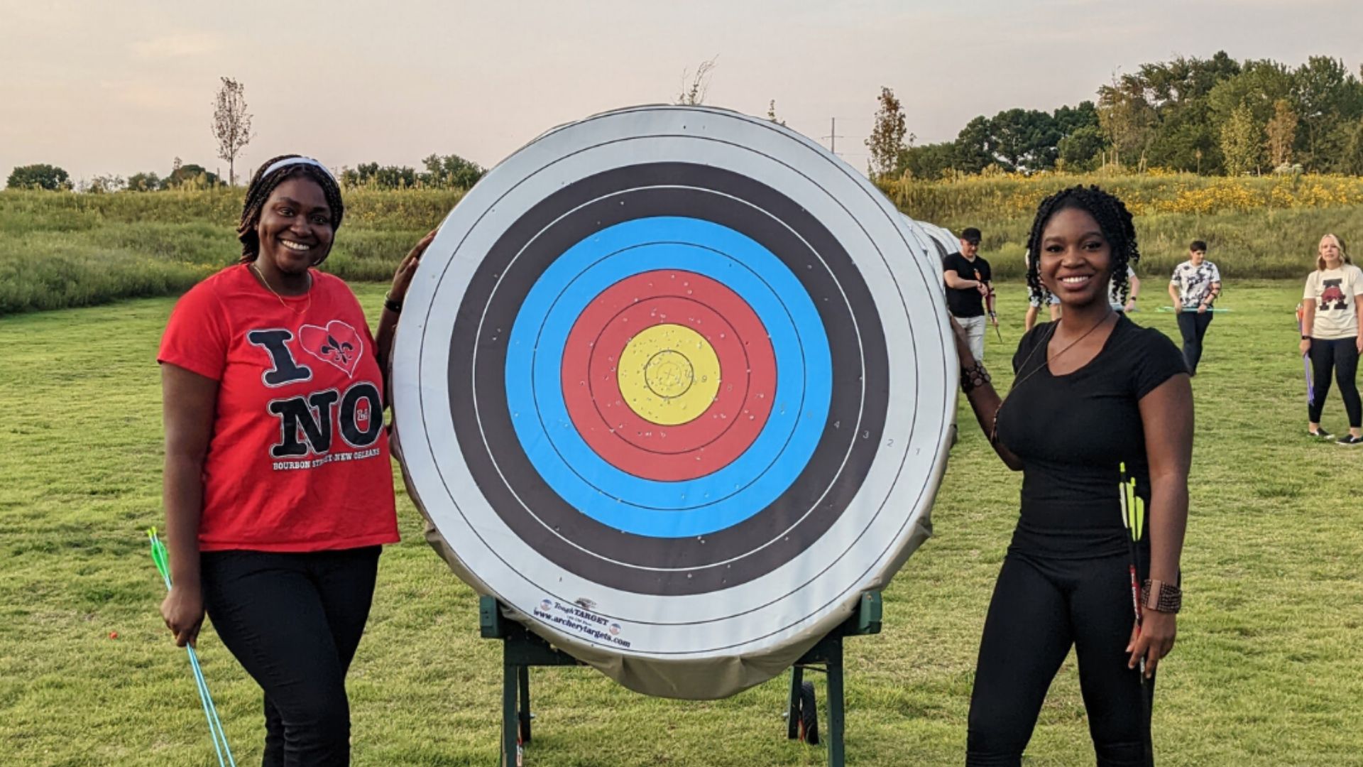 The Quiver Archery Range - Two ladies standing on side of archery target