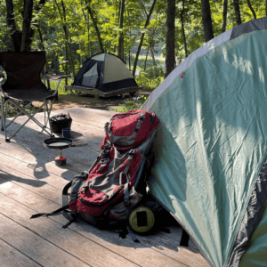 campsite with backpack and cooking tools