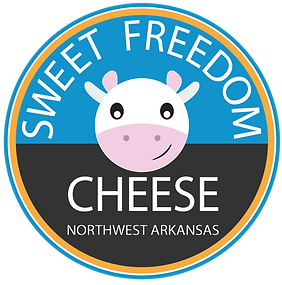 Sweet Freedom Cheese logo (black and blue circle with a cow smiling in the middle, the words "sweet freedom cheese" written around the circle)